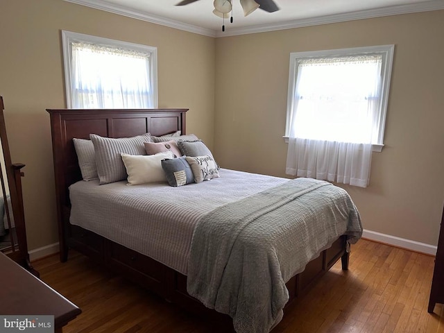 bedroom with crown molding, multiple windows, and hardwood / wood-style floors