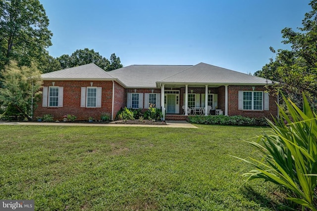 ranch-style home featuring a porch and a front lawn