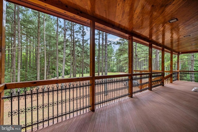 unfurnished sunroom featuring wood ceiling and a wealth of natural light