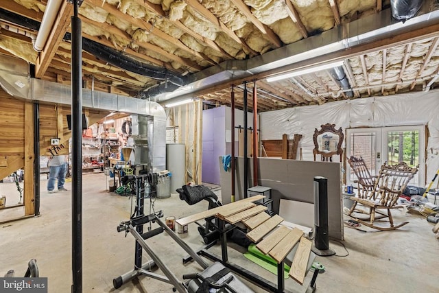 exercise room featuring french doors and water heater