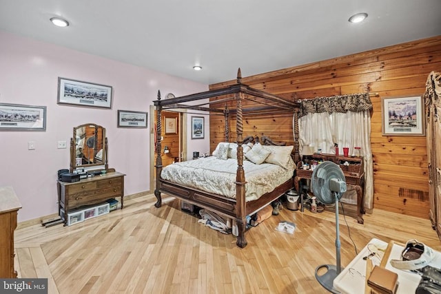 bedroom with wood walls