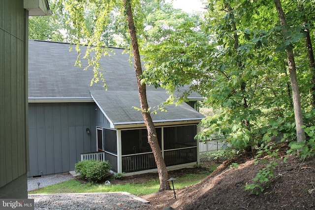 rear view of house featuring a sunroom