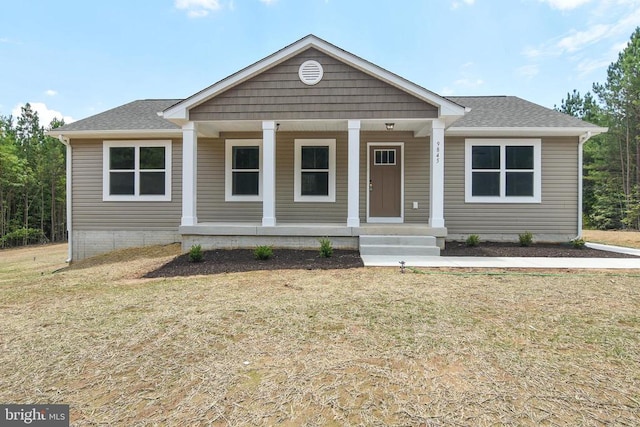 view of front of property featuring covered porch and a front yard