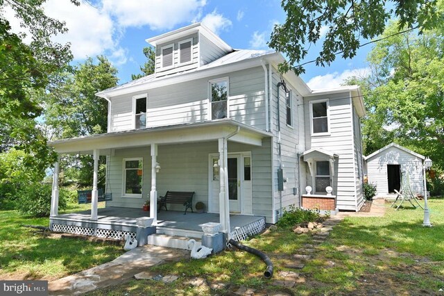 exterior space featuring a lawn and covered porch