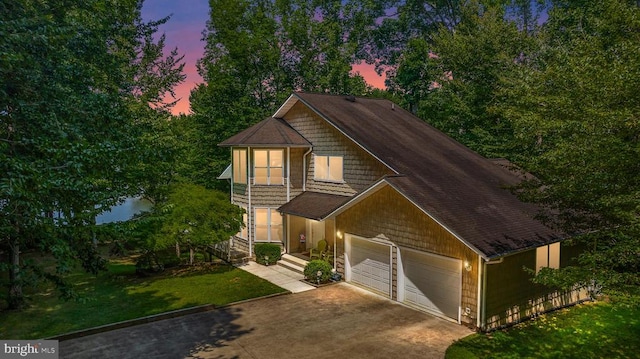 view of front of property featuring a garage and a lawn