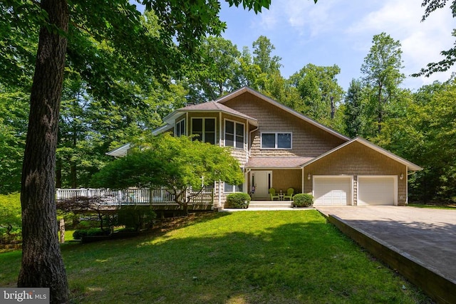 view of front of property featuring a garage and a front lawn