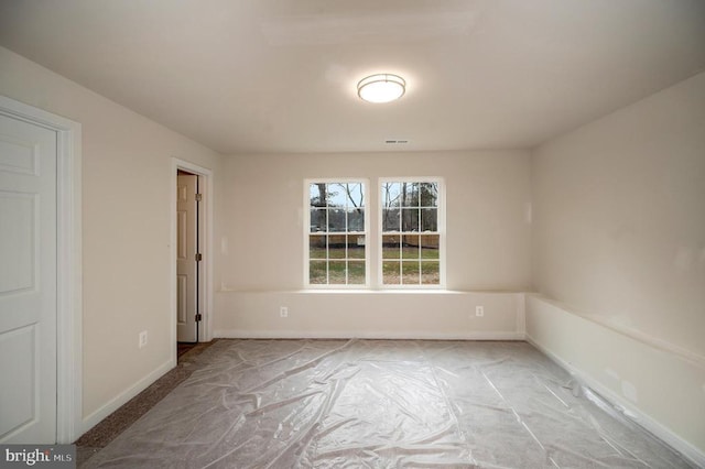 empty room featuring visible vents and baseboards