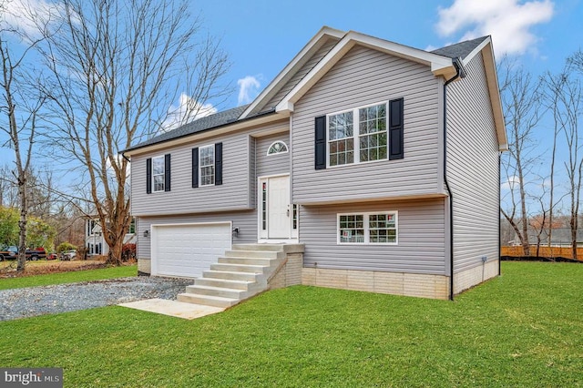 split foyer home with a garage, driveway, and a front lawn