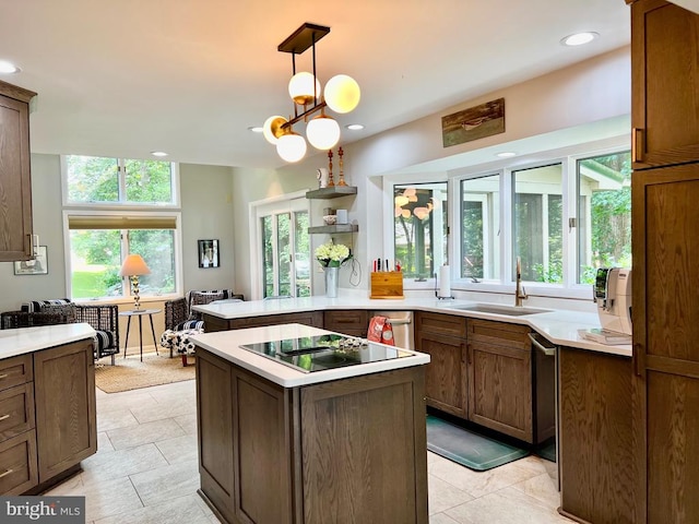 kitchen with sink, decorative light fixtures, kitchen peninsula, and light tile patterned flooring