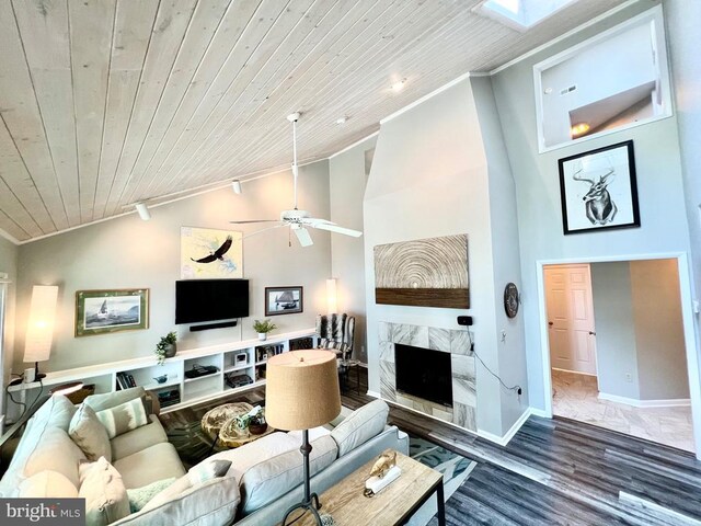 living room with hardwood / wood-style floors, track lighting, ceiling fan, wood ceiling, and a premium fireplace