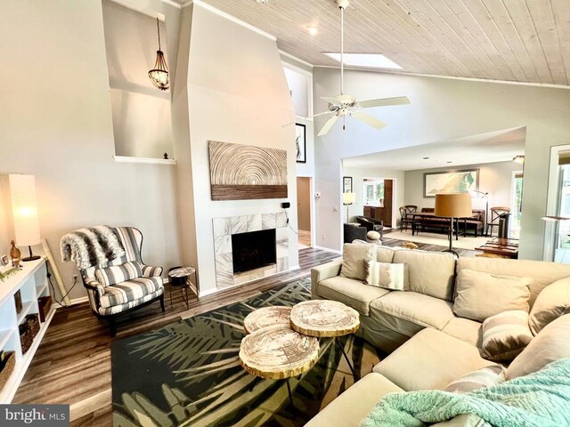 living room featuring ceiling fan, light hardwood / wood-style flooring, wood ceiling, high vaulted ceiling, and a premium fireplace