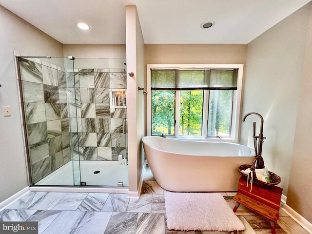 bathroom featuring tile patterned floors and independent shower and bath