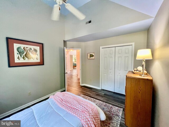 bedroom with a closet, ceiling fan, and dark hardwood / wood-style flooring