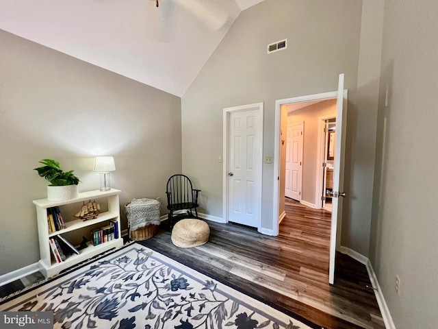 living area featuring high vaulted ceiling and hardwood / wood-style floors