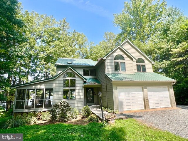 view of front of home with a wooden deck and a front lawn