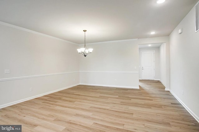 unfurnished room featuring light hardwood / wood-style floors, ornamental molding, and a chandelier