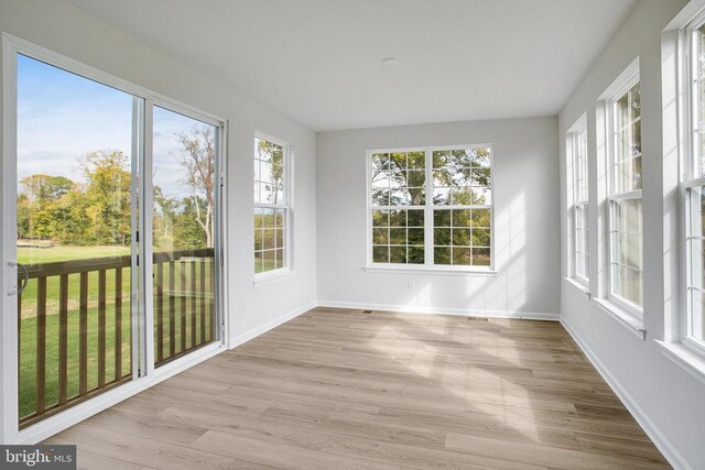 unfurnished sunroom featuring a wealth of natural light