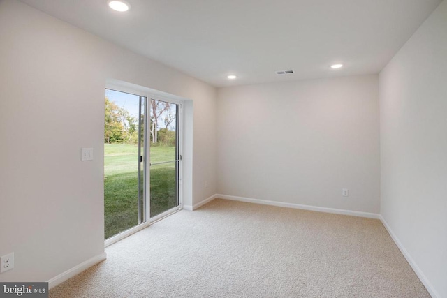 unfurnished room featuring light carpet