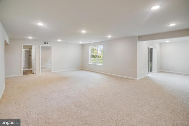 unfurnished room featuring light carpet