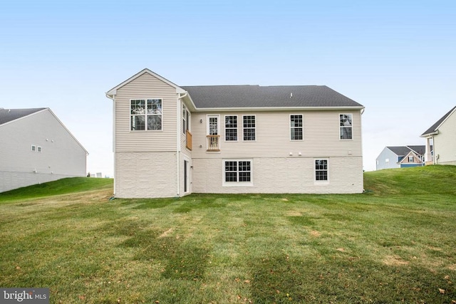 rear view of property featuring a yard