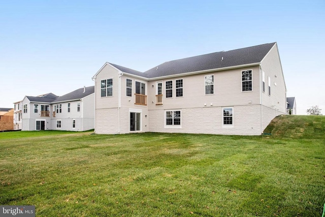 rear view of property featuring a yard