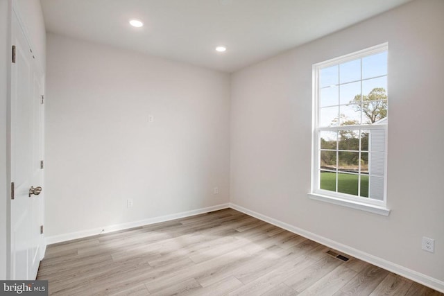 empty room with light hardwood / wood-style floors