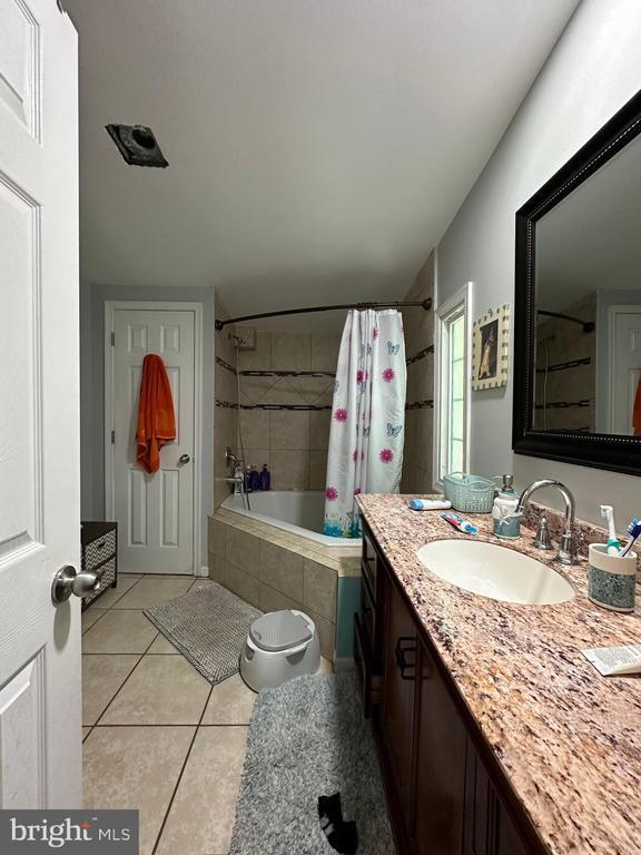 bedroom featuring ceiling fan and hardwood / wood-style floors