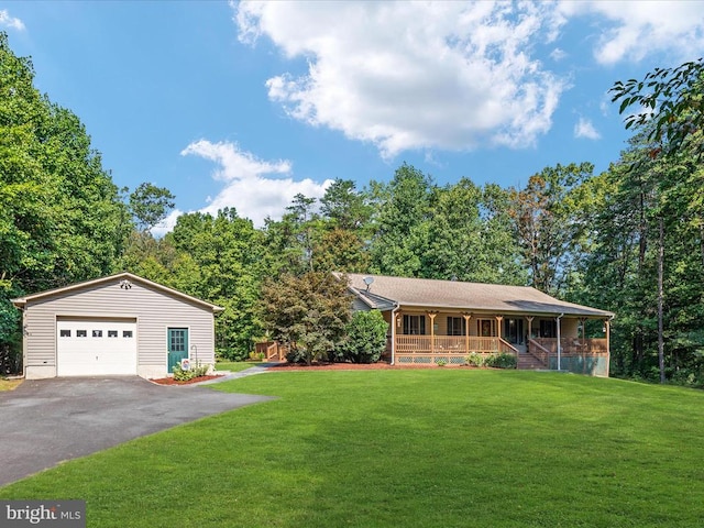 view of front of house with a garage, an outdoor structure, a front yard, and a porch