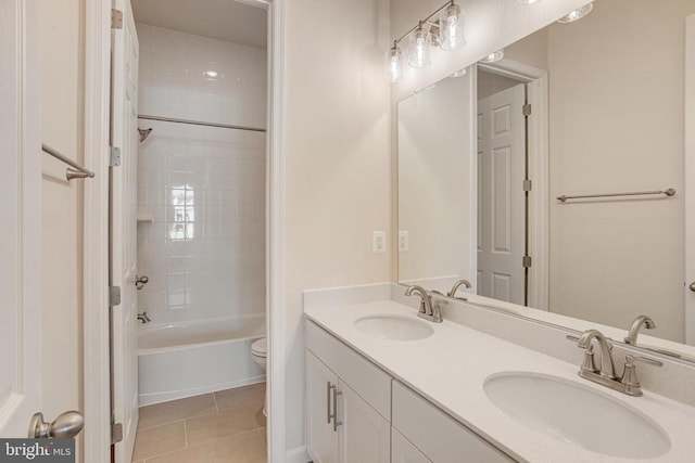 full bathroom with tile patterned floors, tiled shower / bath combo, toilet, and vanity