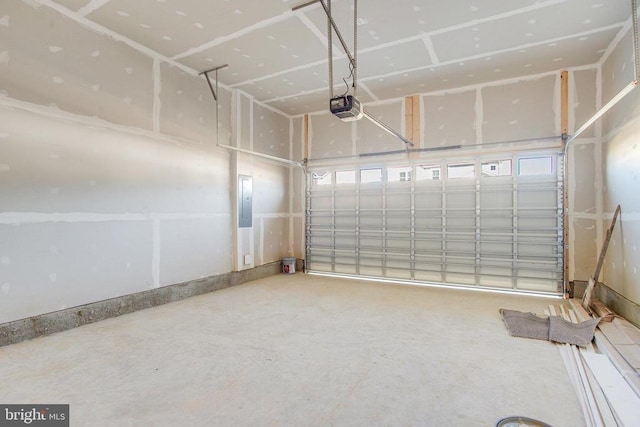 garage with electric panel and a garage door opener