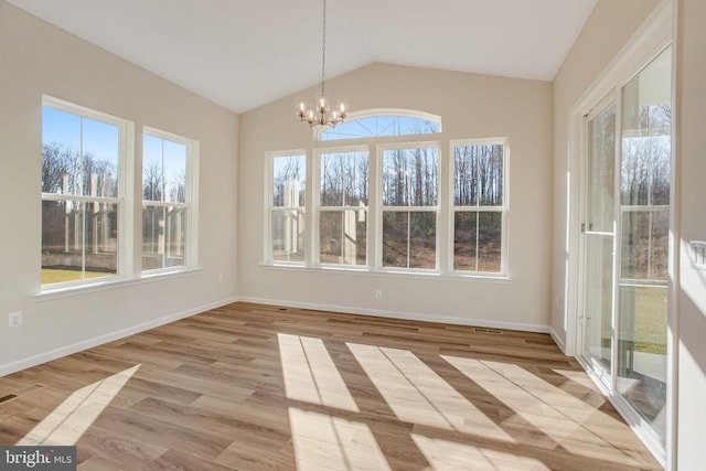 unfurnished sunroom featuring a chandelier and vaulted ceiling