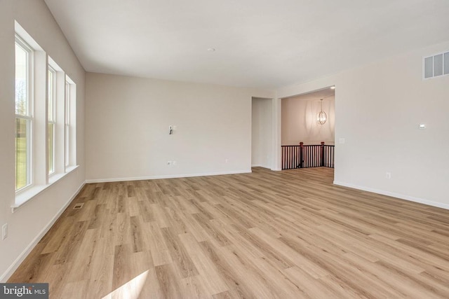 unfurnished room with light wood-type flooring