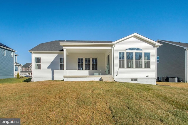 rear view of property with a lawn