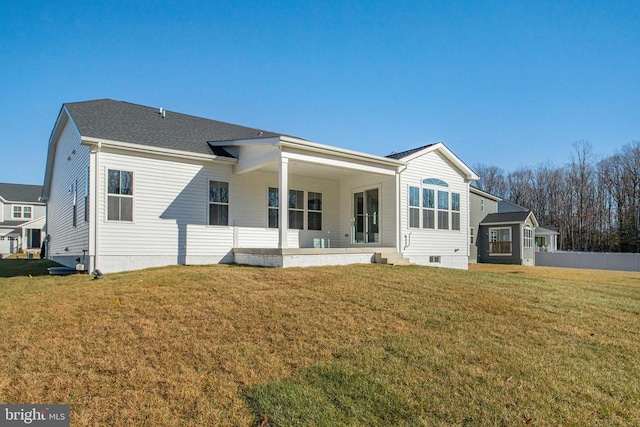 back of house with a lawn