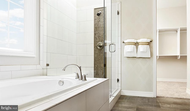 bathroom featuring independent shower and bath and wood-type flooring