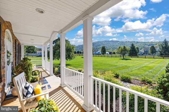 balcony featuring a porch and a rural view