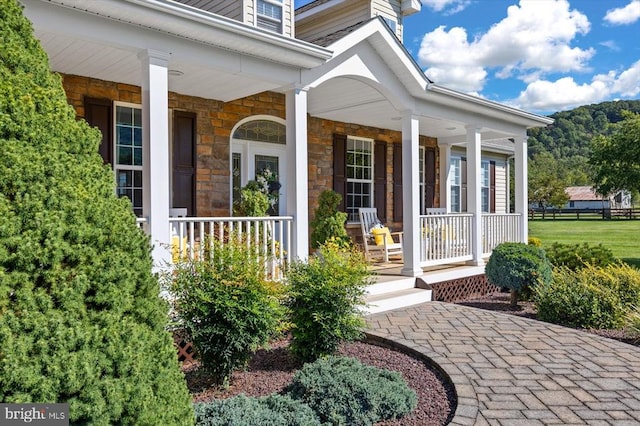 view of exterior entry with covered porch