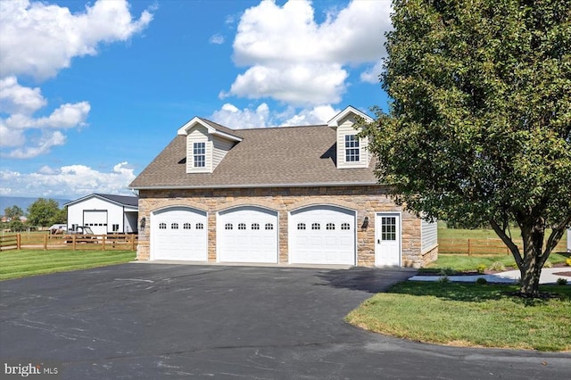 view of side of home with a yard and a garage