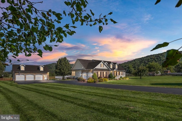 view of front of house with a yard and a garage