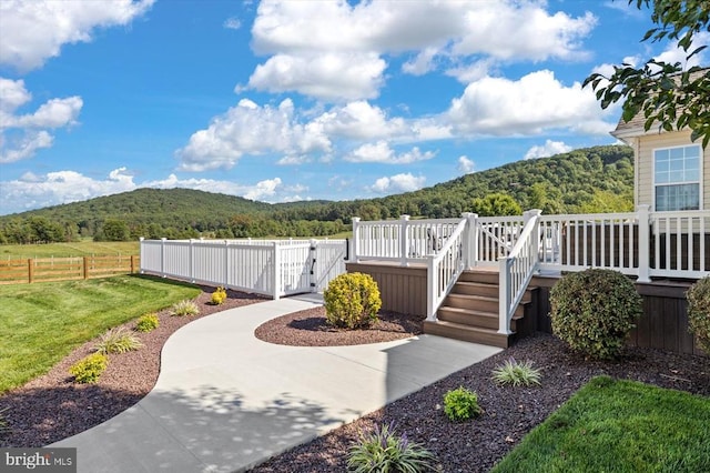 view of yard with a deck with mountain view