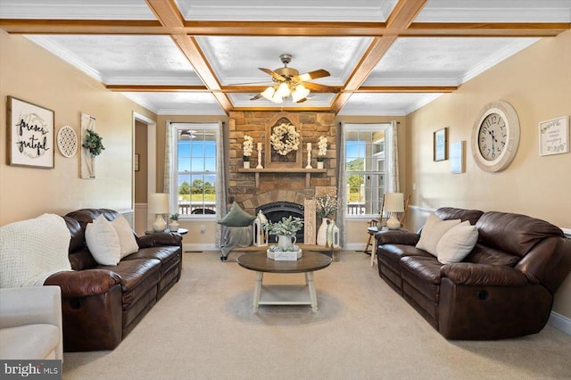 living room featuring carpet, ceiling fan, coffered ceiling, and a stone fireplace