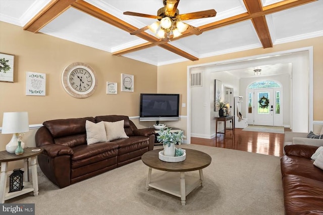 living room with beamed ceiling, hardwood / wood-style flooring, coffered ceiling, and ceiling fan