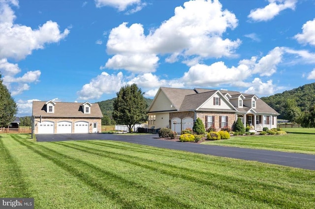 view of front of home with a garage and a front lawn