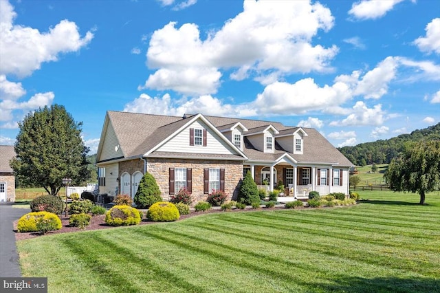 cape cod-style house with a front lawn