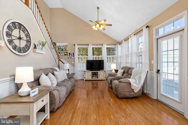 living room featuring high vaulted ceiling, ceiling fan, and light hardwood / wood-style flooring