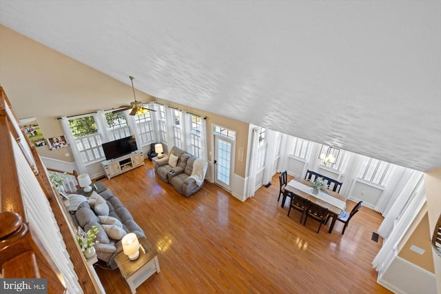 living room with hardwood / wood-style flooring, a wealth of natural light, and ceiling fan