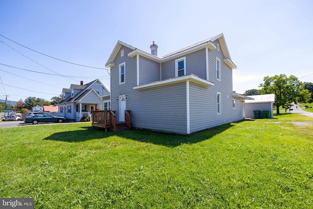 rear view of property with a lawn