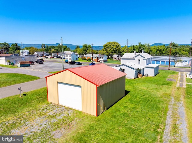 view of outdoor structure featuring a garage and a lawn