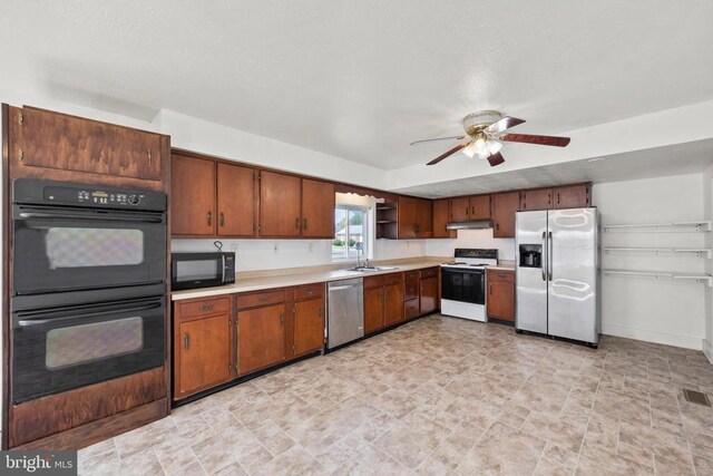 kitchen with black appliances, ceiling fan, and sink