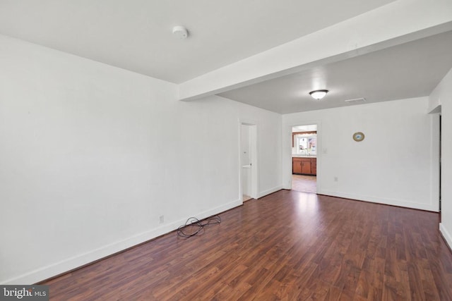 unfurnished room with dark hardwood / wood-style flooring